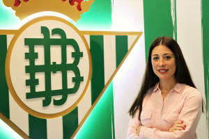 Pilar Castillo Cid stood next to the Real Betis logo with her arms folded