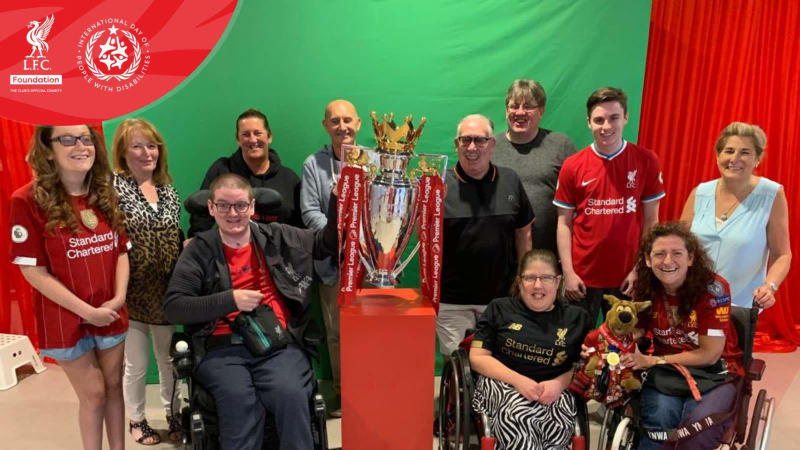 Disabled liverpool fans with the premier league trophy