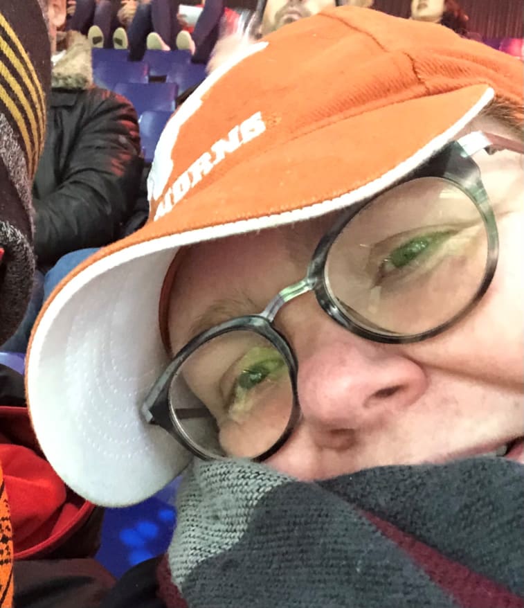 Catelijne at a football game wearing an orange cap