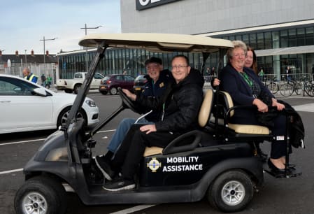 Fans being transported by golf-buggy