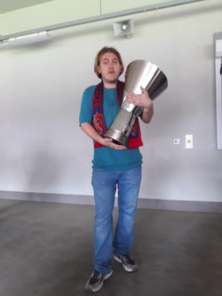 Sergey holding a trophy